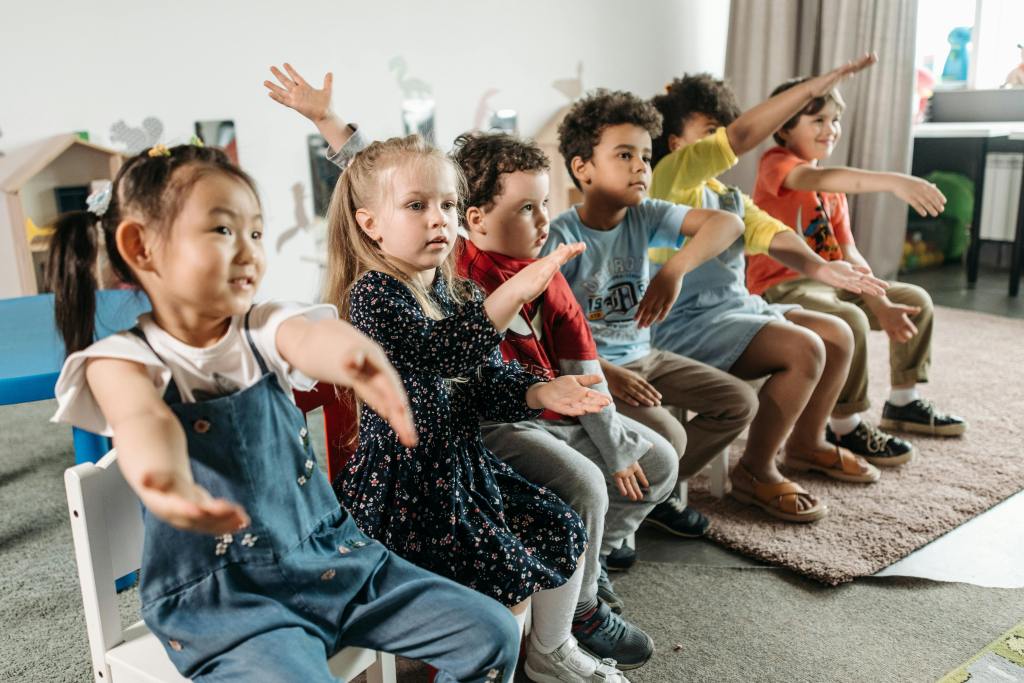 Children doing movement and finger play in circle time