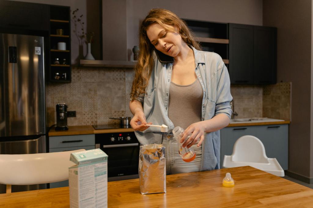 Mom preparing formula for a baby bottle
