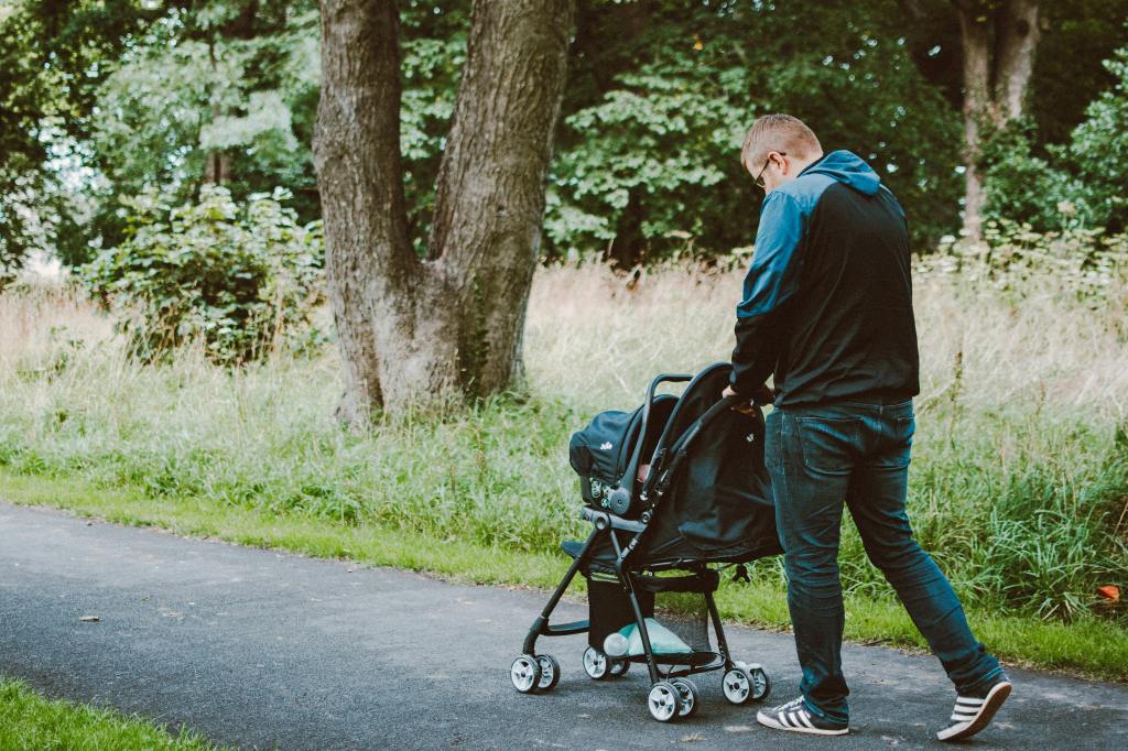Dad pushing stroller with baby