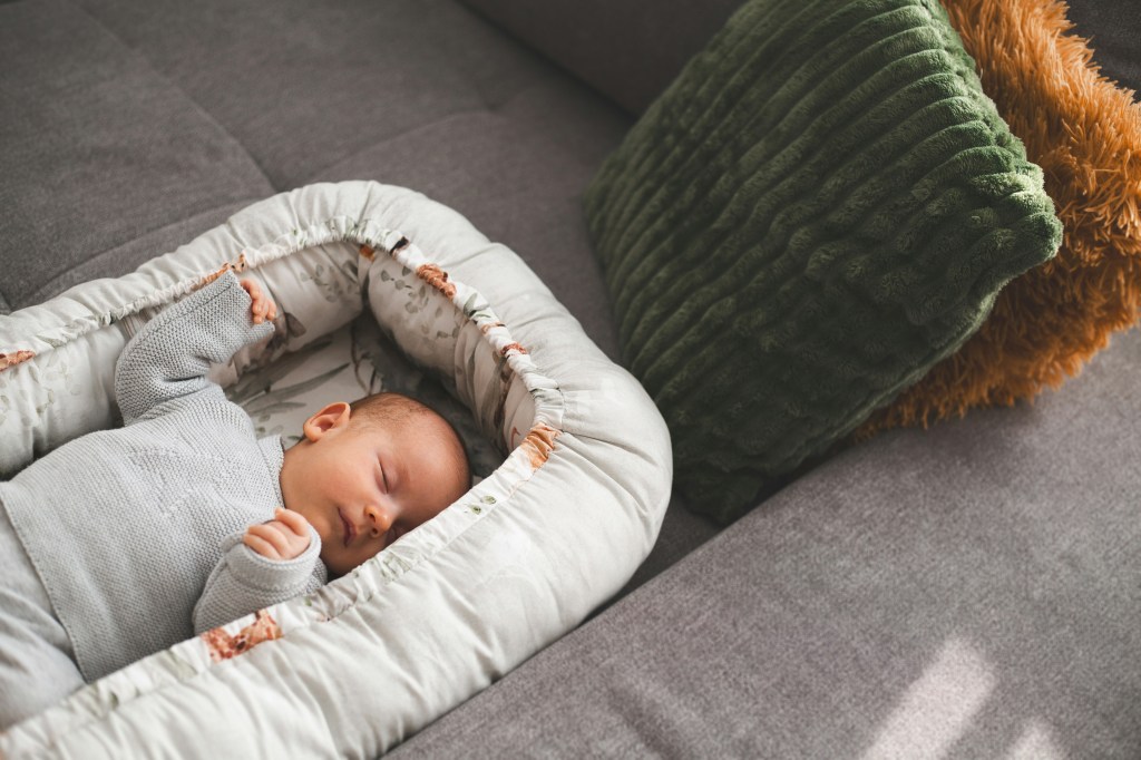 baby napping in couch lounger