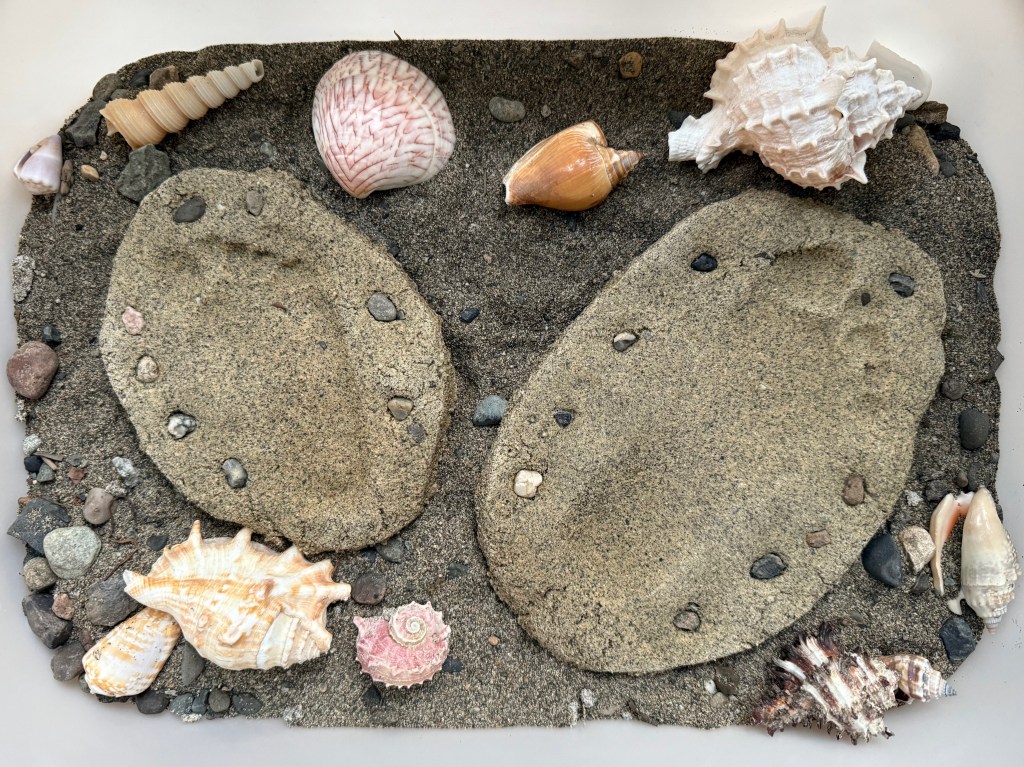child sand footprints